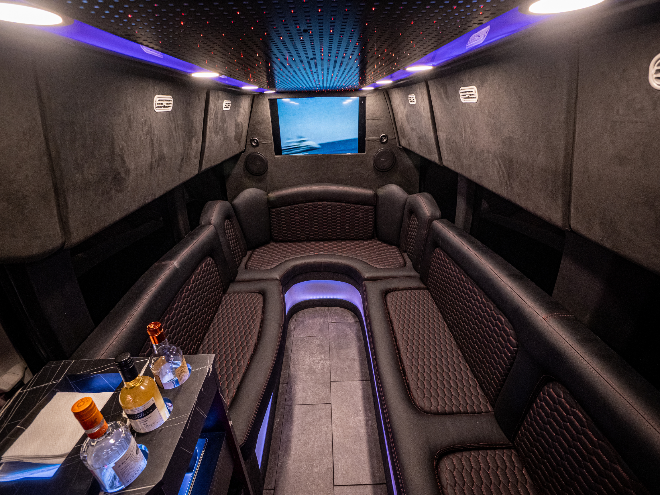 Full interior view of Van Limo party bus in Puerto Rico with mini bar and leather seating