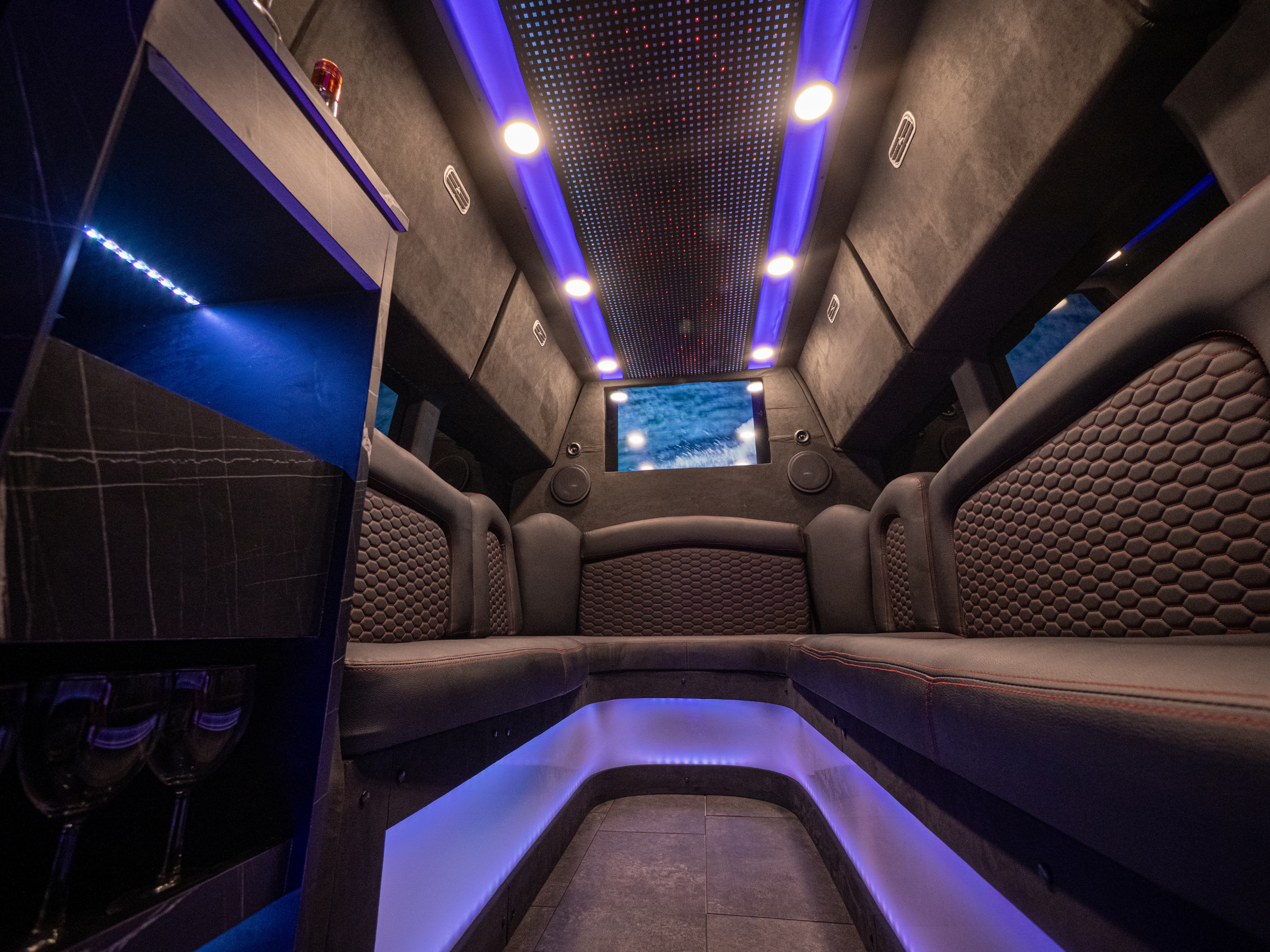 Interior of Van Limo party bus in Puerto Rico with LED lights and leather seating