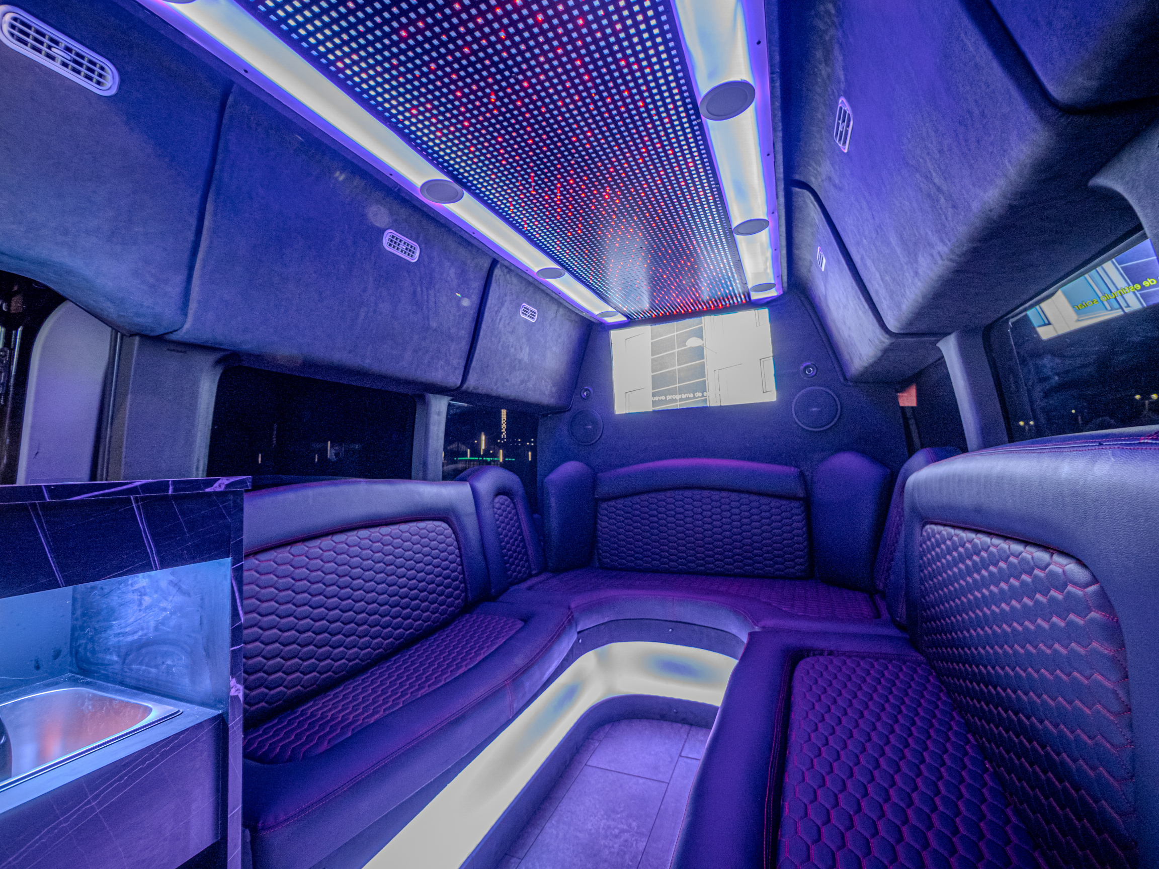 Van Limo parked by the ocean in Puerto Rico at sunset – luxury party bus experience